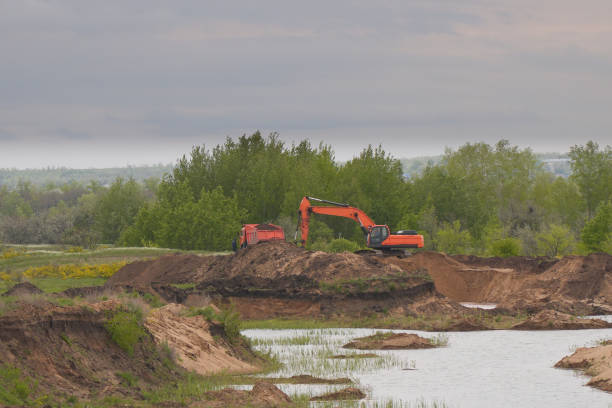istock Excavator and truck in quarry 2187788135