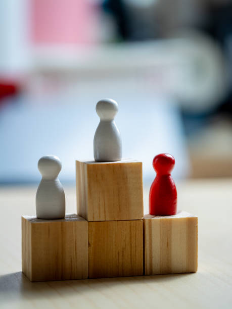 istock Teamwork and progress wooden figures on blocks in an office space concept 2187788282