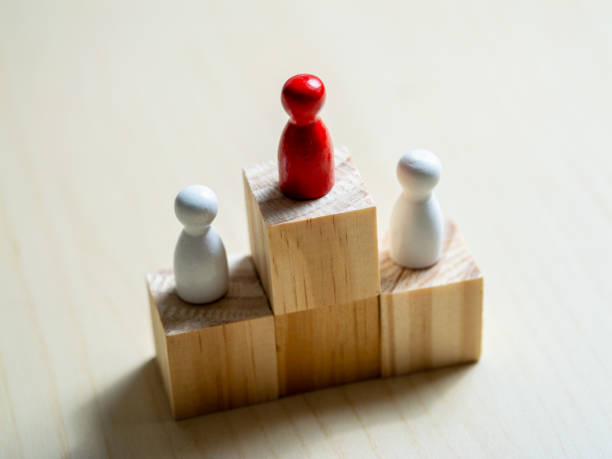 istock Conceptual focus on leadership dynamics minimalist red and white figurines 2187788523