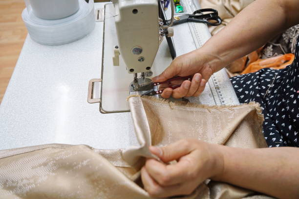 istock The tailor is sewing curtains for windows 2187791618