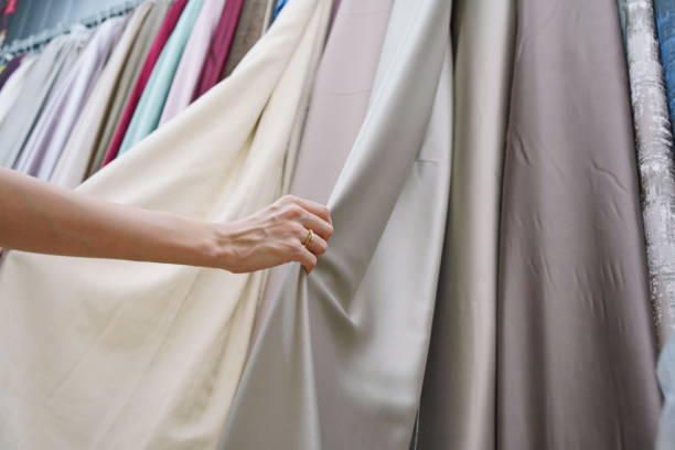 istock The customer is choosing curtains for windows in a store. 2187791634