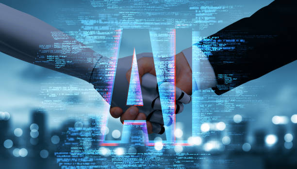 istock Handshake between human and robot with AI text overlay on digital background. 2187792497