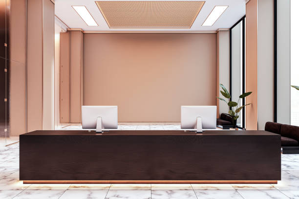 istock Modern reception desk in a spacious corporate lobby with marble flooring, backlit counter, and computer screens. Contemporary design. 3D Rendering 2187792602