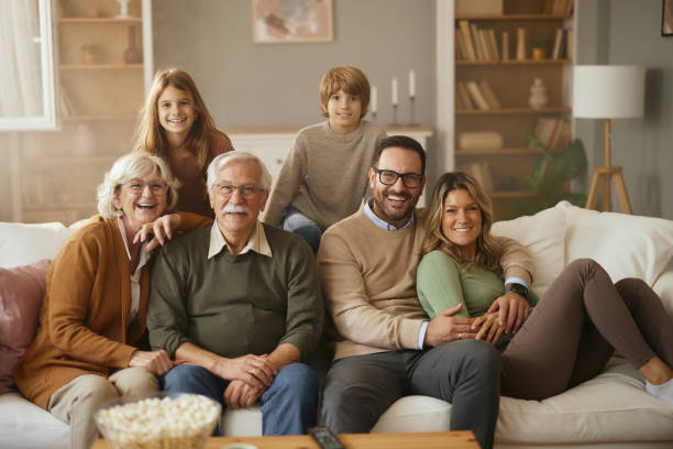 istock Happy extended family relaxing on sofa at home. 2187794641