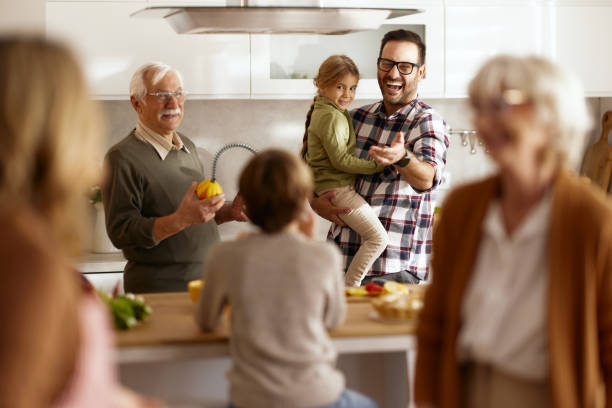 istock Happy extended family talking in the kitchen. 2187794863