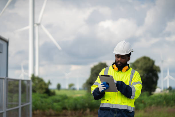 istock Service engineers checking system of windmill. Wind turbines generate electricity. Clean and Renewable energy concept. 2187794971