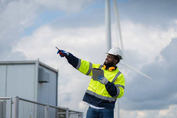 istock Service engineers checking system of windmill. Wind turbines generate electricity. Clean and Renewable energy concept. 2187795005