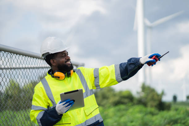 istock Service engineers checking system of windmill. Wind turbines generate electricity. Clean and Renewable energy concept. 2187795044