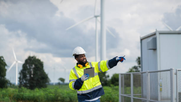 istock Service engineers checking system of windmill. Wind turbines generate electricity. Clean and Renewable energy concept. 2187795056