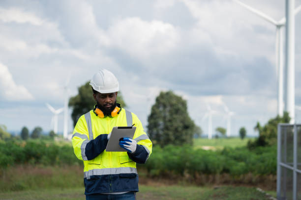 istock Service engineers checking system of windmill. Wind turbines generate electricity. Clean and Renewable energy concept. 2187795263