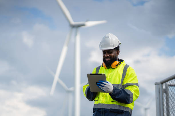 istock Service engineers checking system of windmill. Wind turbines generate electricity. Clean and Renewable energy concept. 2187795382