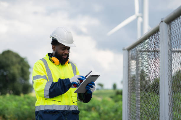 istock Service engineers checking system of windmill. Wind turbines generate electricity. Clean and Renewable energy concept. 2187795393