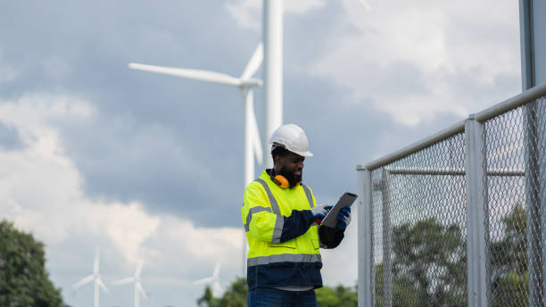 istock Service engineers checking system of windmill. Wind turbines generate electricity. Clean and Renewable energy concept. 2187795406
