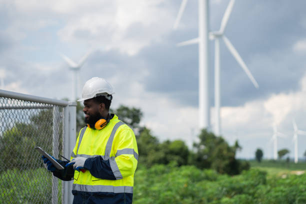 istock Service engineers checking system of windmill. Wind turbines generate electricity. Clean and Renewable energy concept. 2187795425