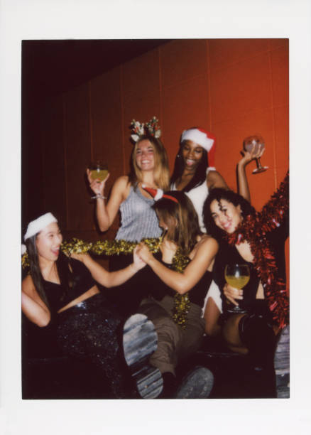 A group of friends enjoying a festive celebration with drinks and decorations. Captured with an instant camera, this image exudes a vintage vibe with a dusty, scratched look.