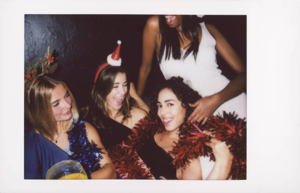istock Joyful friends celebrating with festive hats and garlands 2187796565