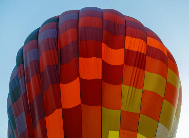 istock A hot air balloon with a colorful pattern is floating in the sky 2187796619