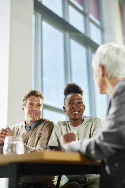 istock Happy diverse couple having a meeting with their agent in the office. 2187796801