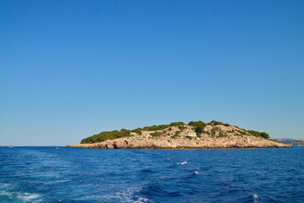 istock Rocky Island Surrounded in Blue Sea at Summer Day 2187796857