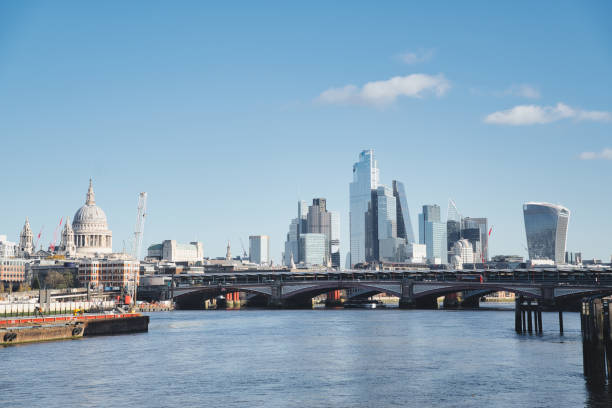 istock Panoramic view of london's iconic skyline featuring st. Paul's cathedral, modern skyscrapers, and blackfriars bridge spanning the river thames on a clear, sunny day 2187796904