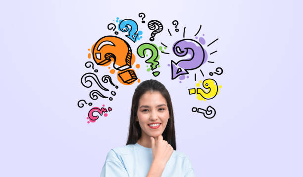 istock Woman smiling with colorful question marks around her head on a 2187796962