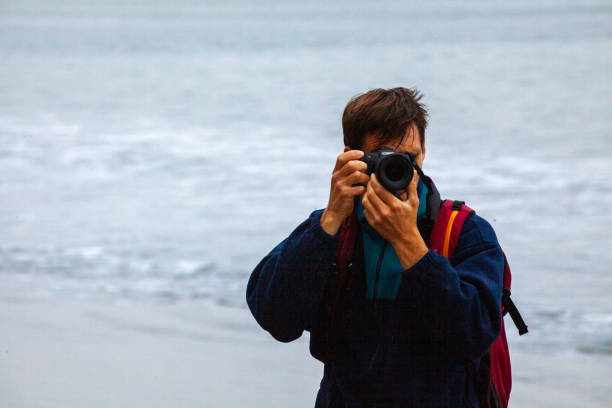istock Photographer explores moody coastline 2187797473