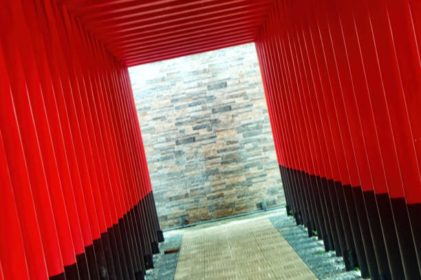 Red and black corridor with a modern stone wall background, creating a striking architectural perspective. Ideal for themes related to contemporary design and urban environments