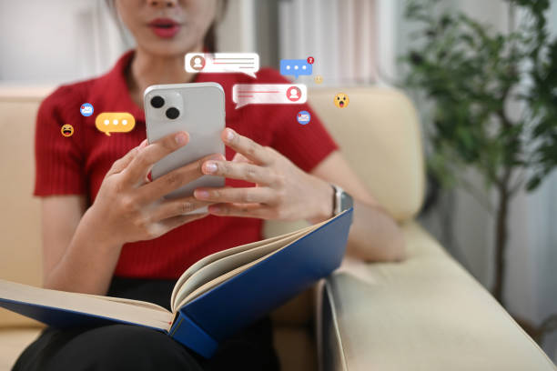 istock Woman checking her smartphone surrounded by floating message and social media notifications bubbles 2187797698