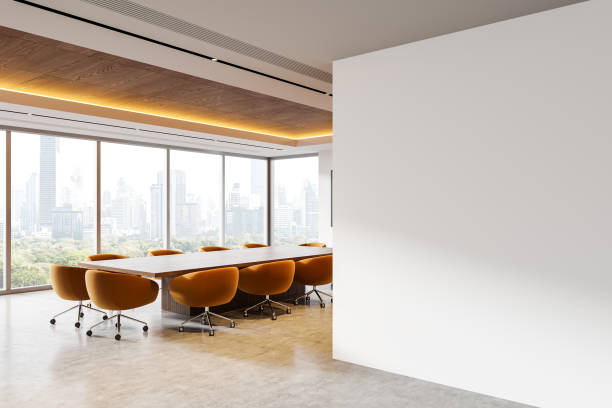 istock Light meeting interior with table and chairs, tv screen and window. Mockup wall 2187797860