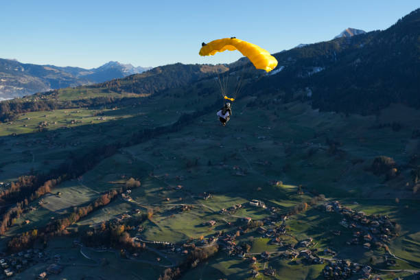 istock Paraglider soars over lush valley, Swiss Alps 2187798117