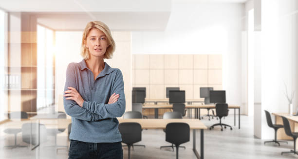 istock Woman standing confidently in a modern office environment with a 2187798162