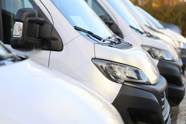 istock White vans one behind the other - view from the side 2187799522