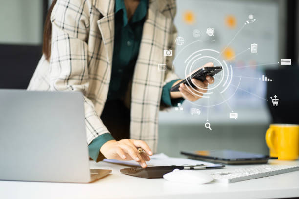 istock Professional businesswoman analyzing stats and graphs on paperwork outside a modern office building. Ideal for themes of success, analysis, and corporate growth. 2187800569
