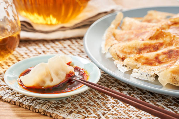istock Dumplings Commonly Eaten in Japan - Crispy Pan-Fried Gyoza 2187800646