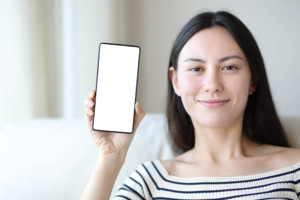 istock Asian woman showing blank phone screen at home 2187803149