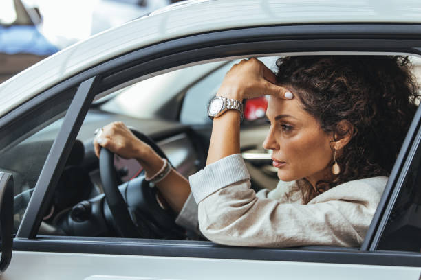 istock Thoughtful Woman Sitting in Car During Daytime Commute 2187803210