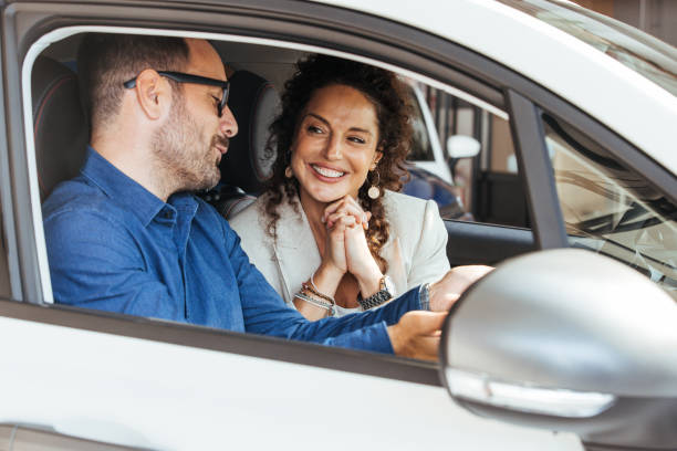 istock Happy Couple Enjoying a Moment Inside Their New Car 2187803213