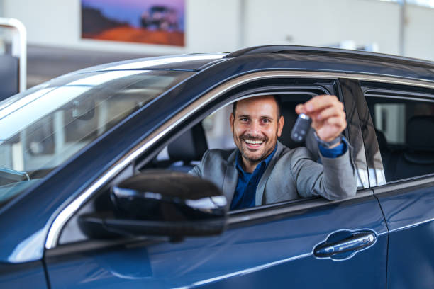 istock Happy Man Holding Car Keys Inside New Blue Vehicle 2187803227