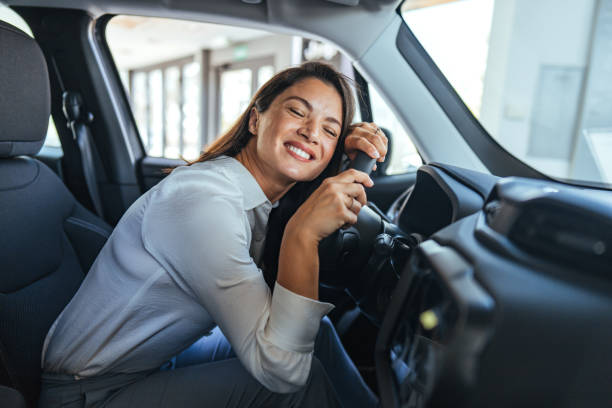 istock Happy Woman Embracing New Car Purchase with Joyful Expression 2187803252