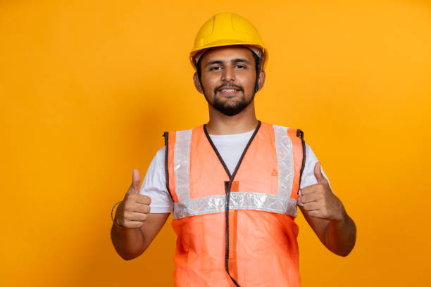istock Confident Construction Worker in Safety Gear on Yellow Background 2187804831