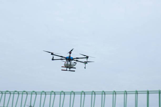 istock Agriculture drone flying and spraying fertilizer 2187805201
