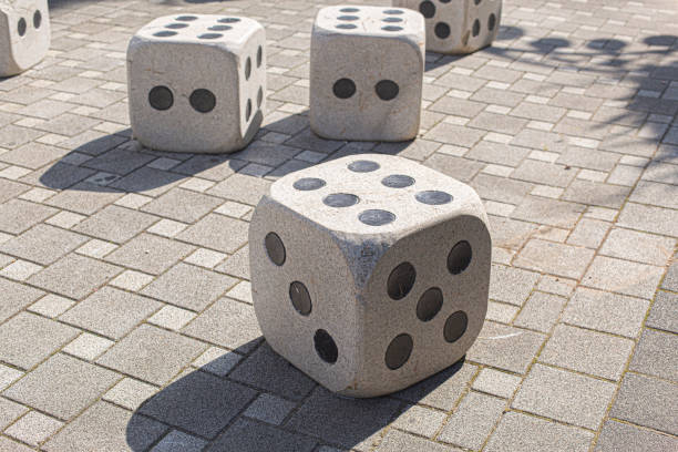 istock Oversize dice with six dots at the street. 2187805301