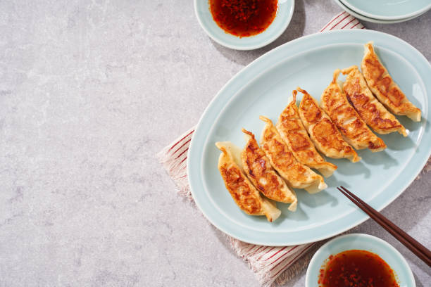 istock Dumplings Commonly Eaten in Japan - Crispy Pan-Fried Gyoza 2187805543