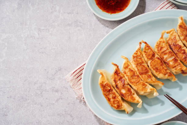 istock Dumplings Commonly Eaten in Japan - Crispy Pan-Fried Gyoza 2187805566