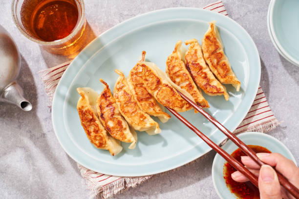 istock Dumplings Commonly Eaten in Japan - Crispy Pan-Fried Gyoza 2187805568