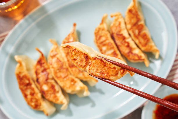 istock Dumplings Commonly Eaten in Japan - Crispy Pan-Fried Gyoza 2187805644