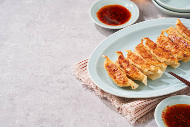 istock Dumplings Commonly Eaten in Japan - Crispy Pan-Fried Gyoza 2187805672