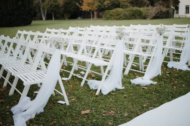 istock Outdoor wedding setup with white chairs and floral decor. 2187805961
