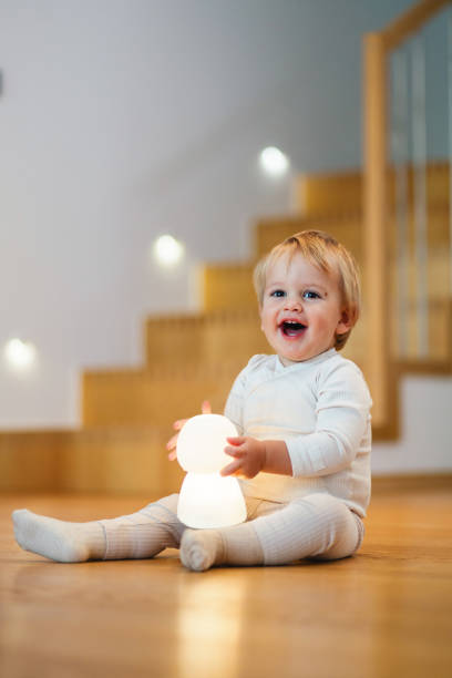 istock Adorable Baby Laughing with Light Toy Indoors 2187806324