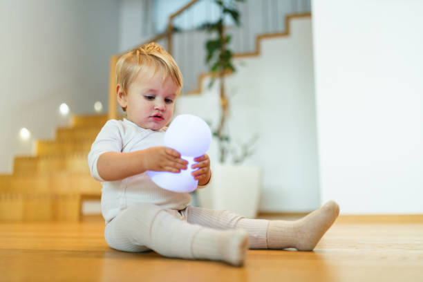 istock Adorable Baby Playing with Glowing Toy 2187806350